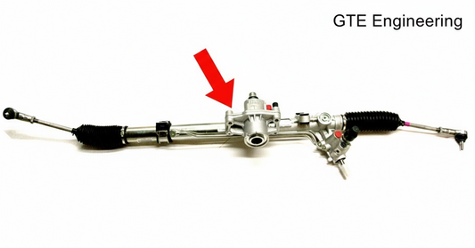 Steering rack assembly with its housing highlighted by an arrow