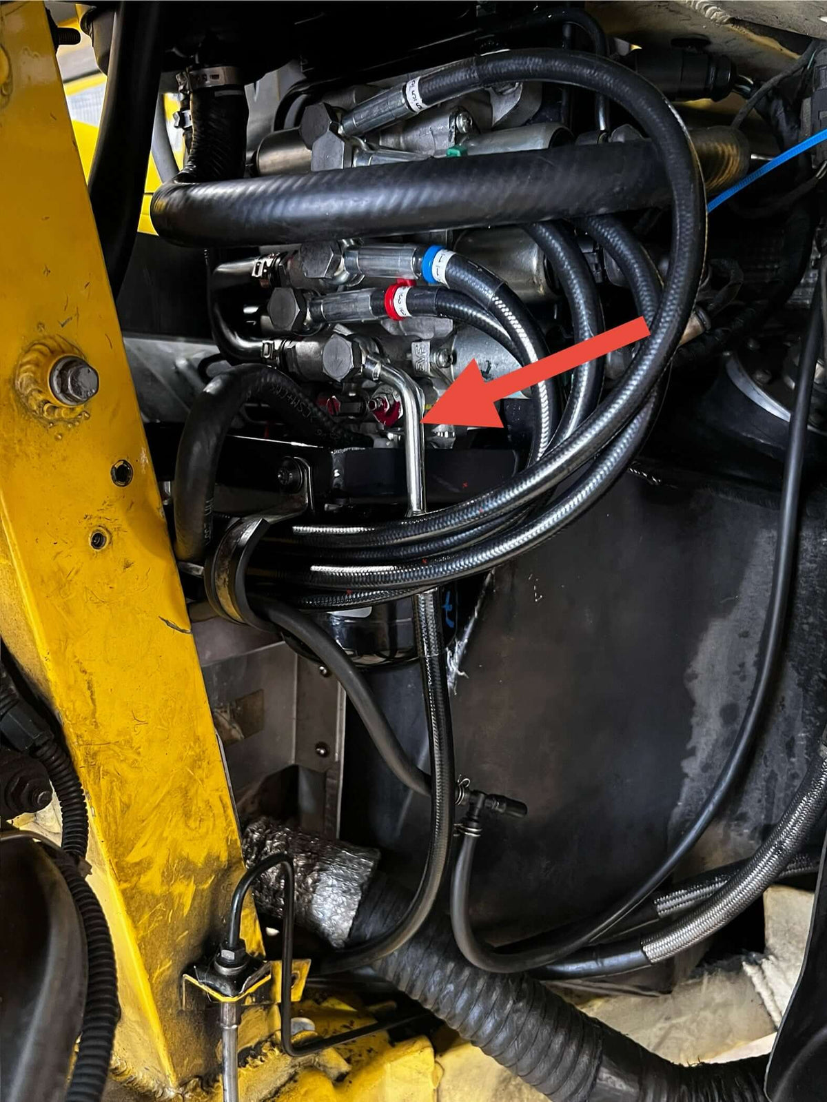 Lamborghini Gallardo clutch hose routing with fitting indicated by red arrow